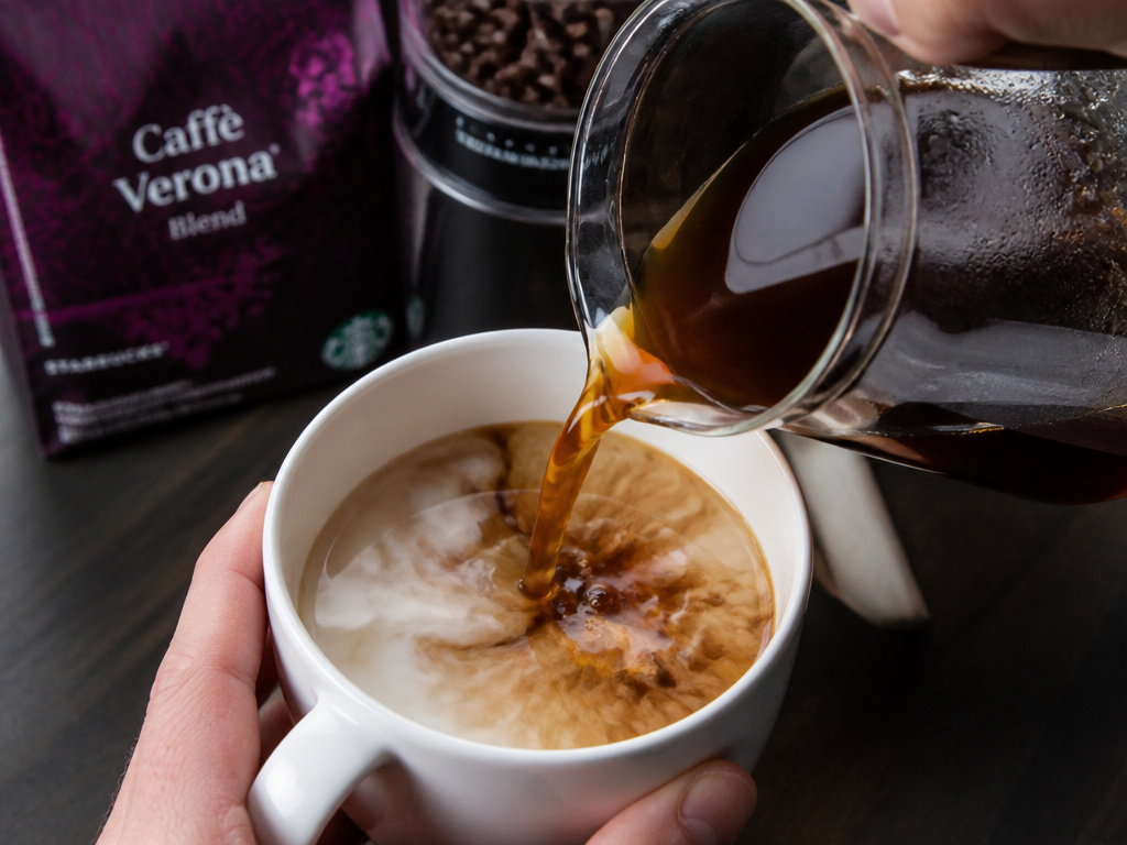 Close-up of brewing coffee into steamed milk to make a classic misto.