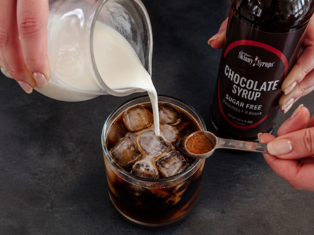 Customizing dairy-free and healthy mocha iced coffee with oat milk and cinnamon.