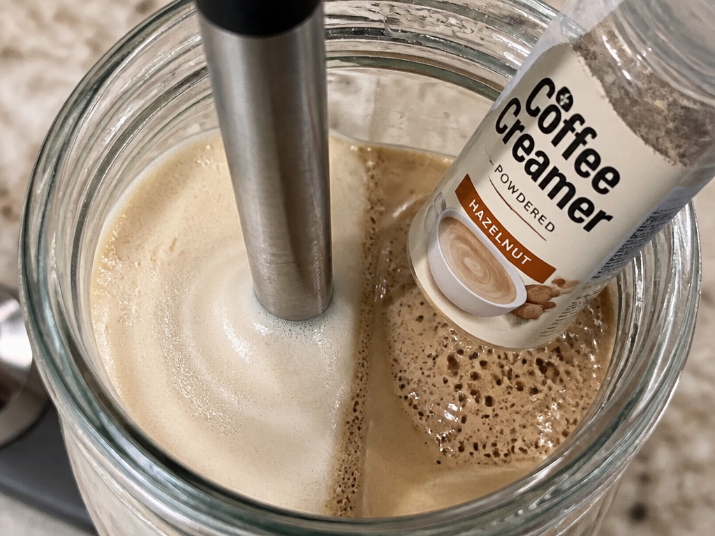 Successful frothy oat milk versus failed powdered creamer in a frother.