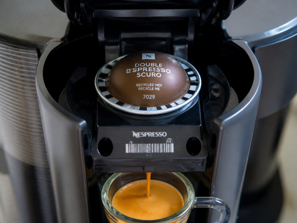 Close-up of a Nespresso VertuoLine brewing a double espresso pod.